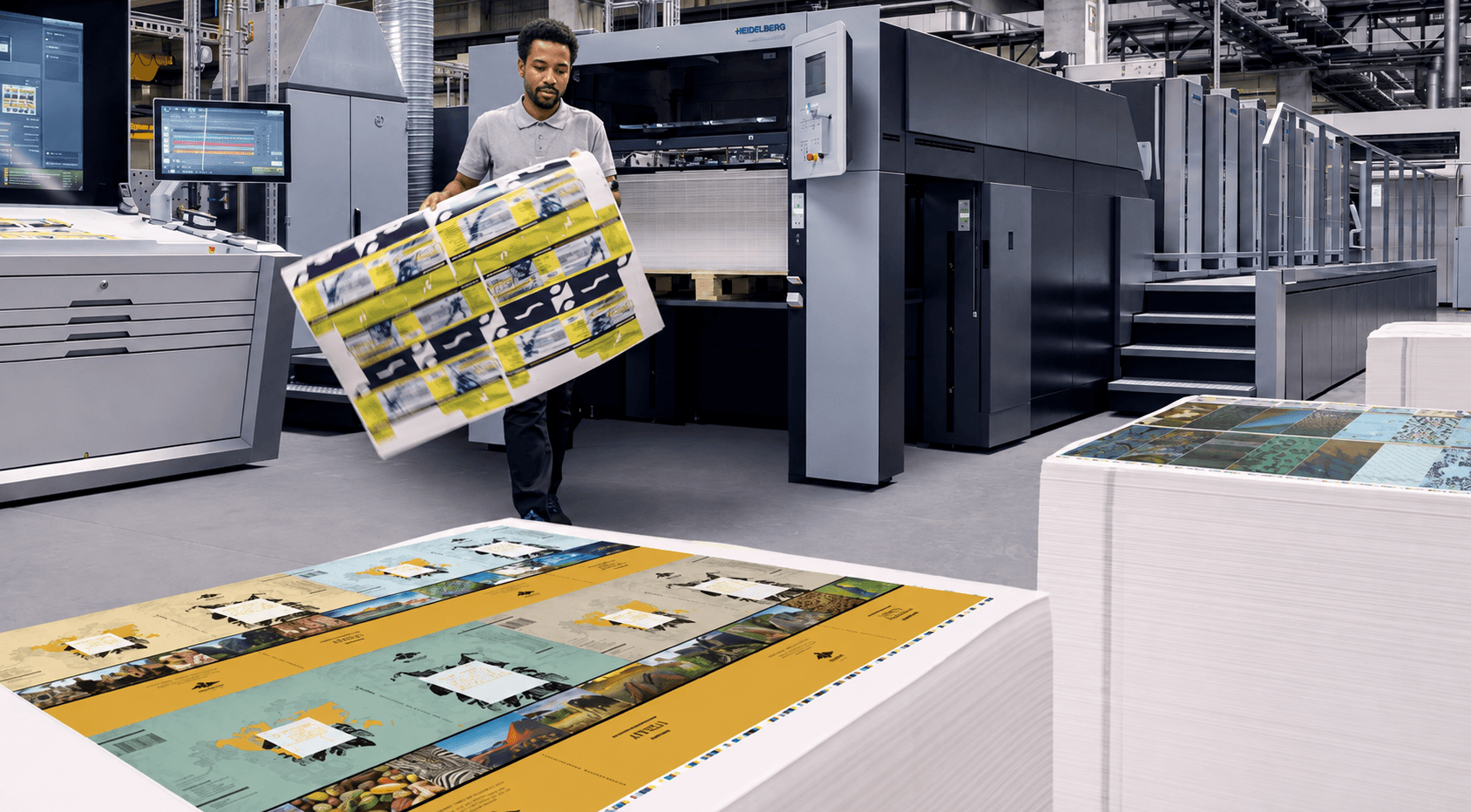 A Fulas operator pulling a freshly printed sheet from the Heidelberg Speedmaster offset press